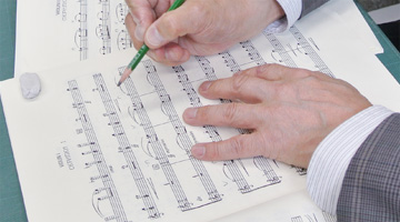 In string-instrument scores, “bowings” (indications of bow-movement direction) are carefully penciled in one by one.